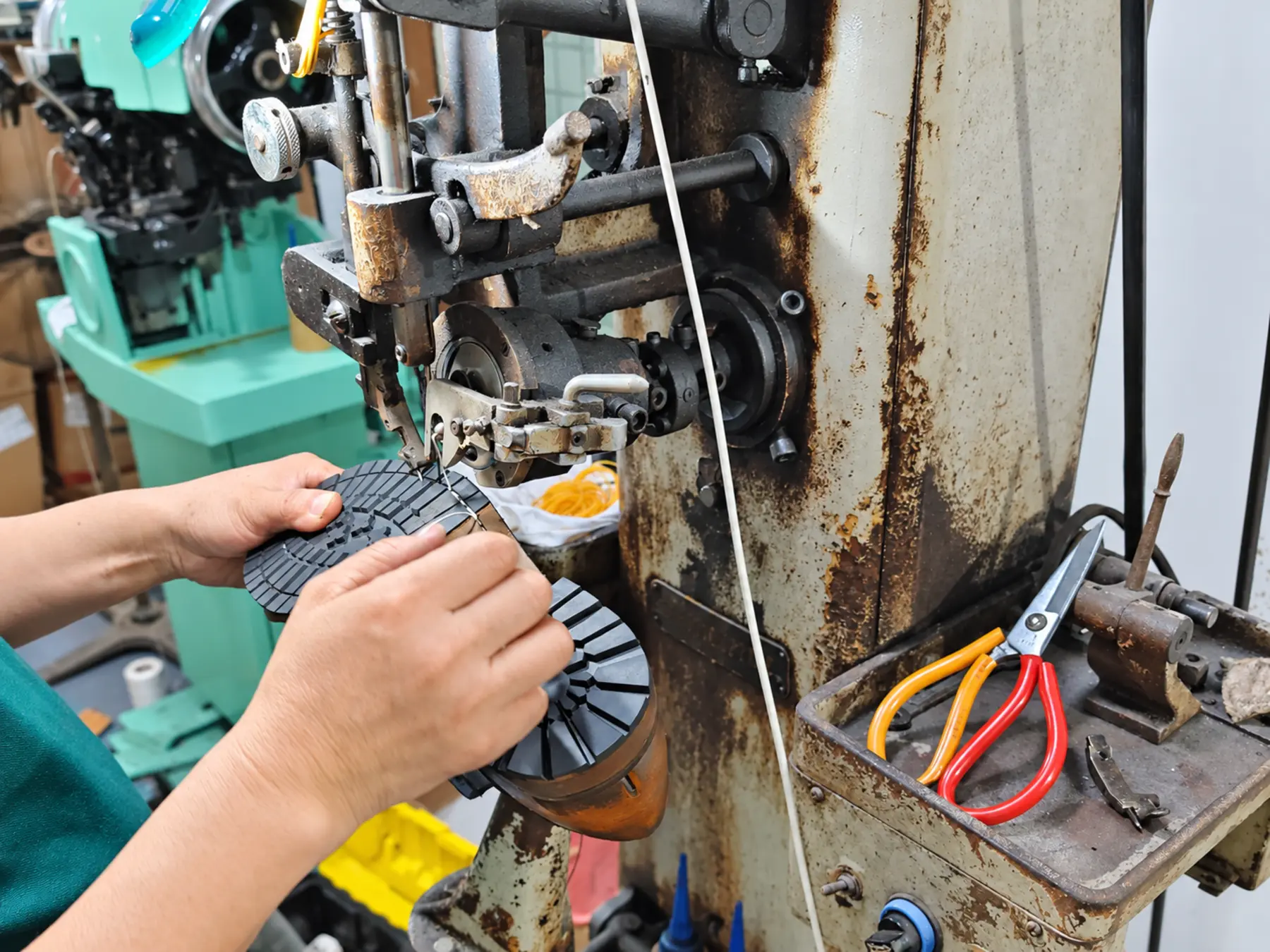 Qineng craftsperson working on an outsole in the workshop
